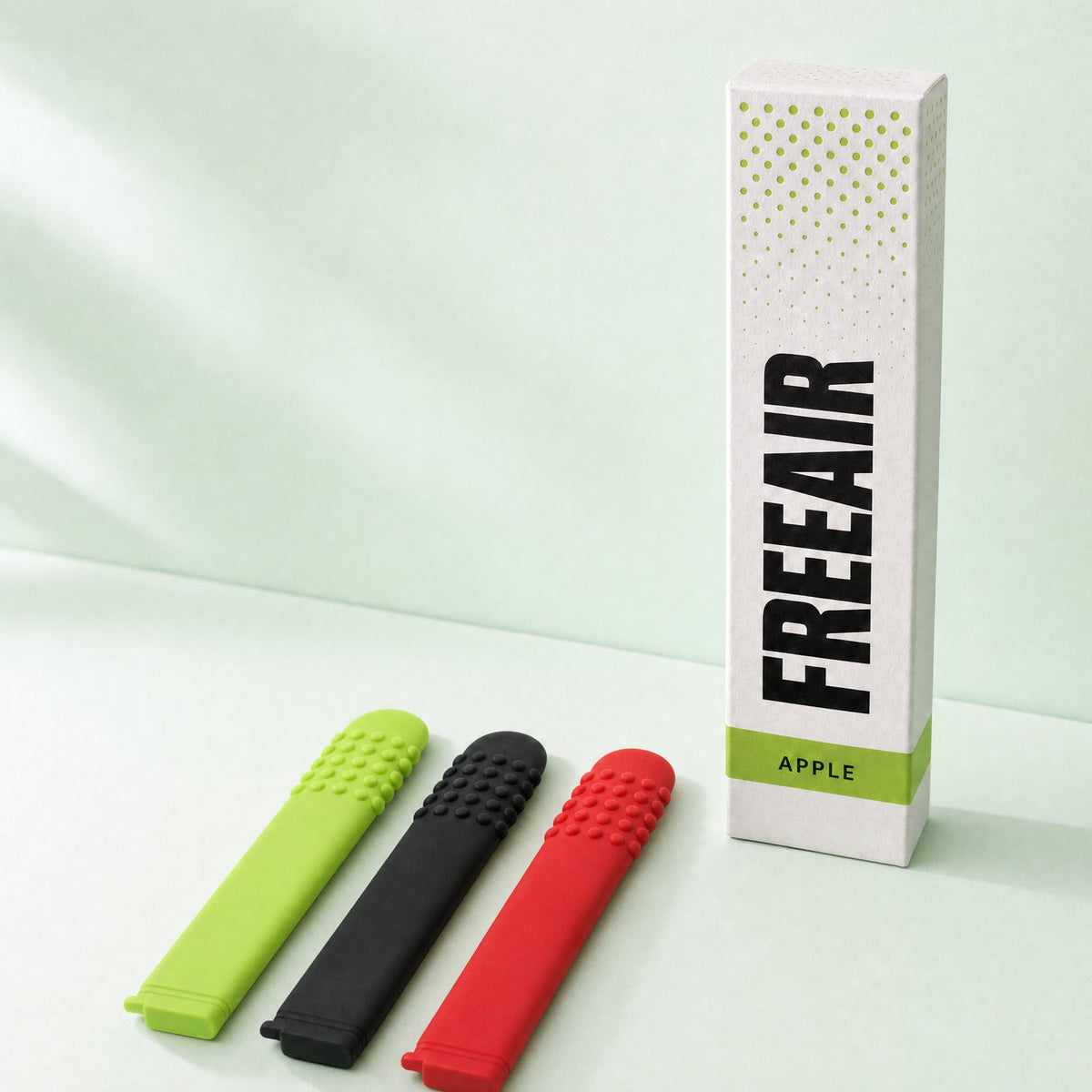 FreeAir box with lime, black and red flat chewable breathers on a mint background