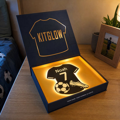Navy Kitglow gift box with amber foil jersey and inner tray