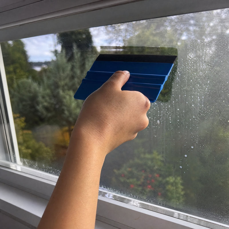 Smoothing the film with a squeegee