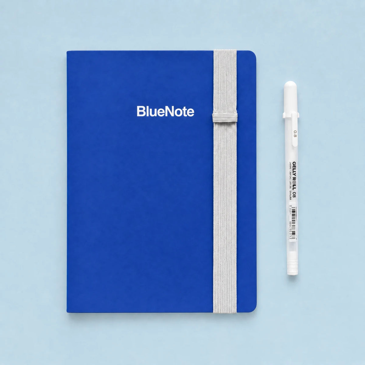 One blue notebook, one white gel pen and the fitted external pen strap