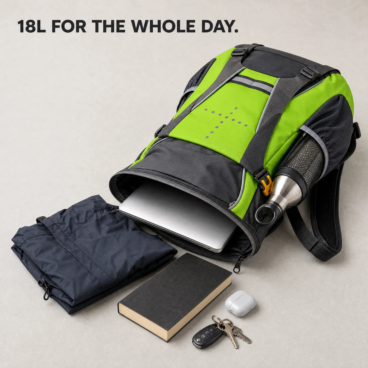 Beacon open with a laptop, rain jacket, bottle, book and keys