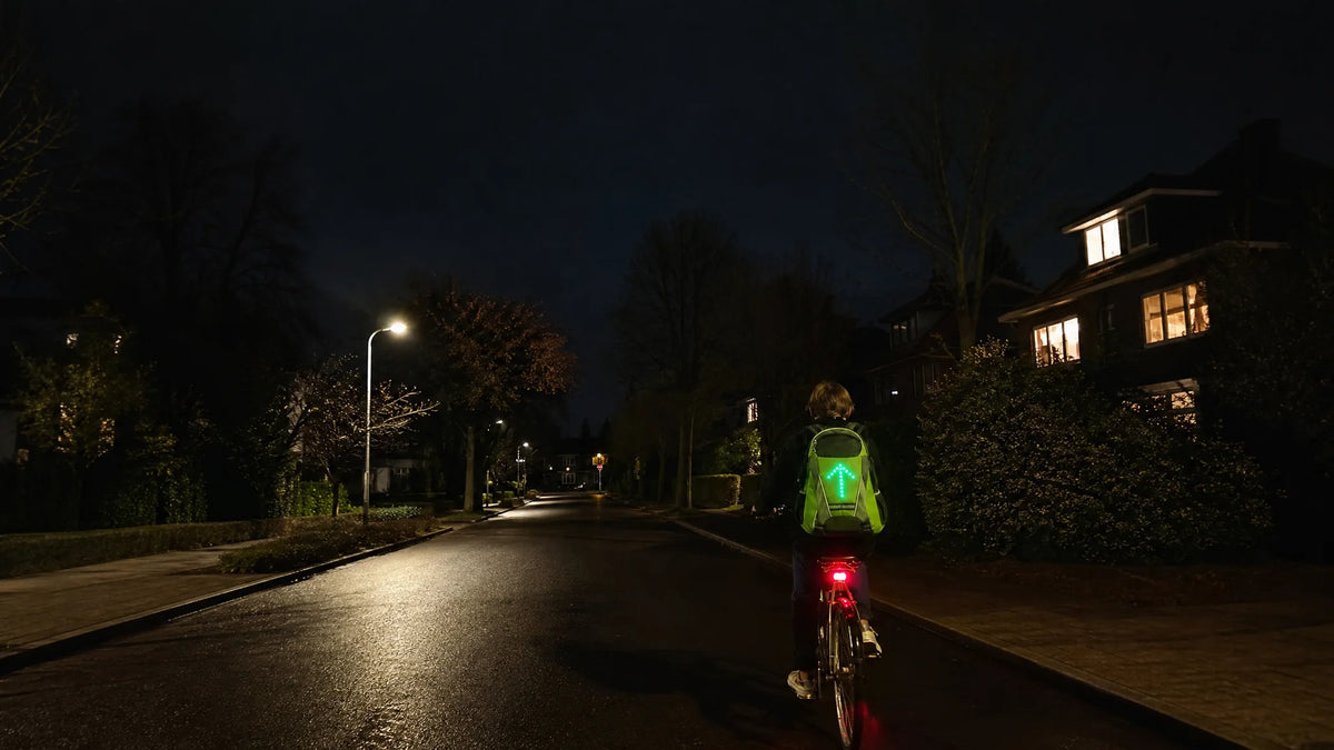 Cyclist riding home at night with Beacon showing a forward arrow