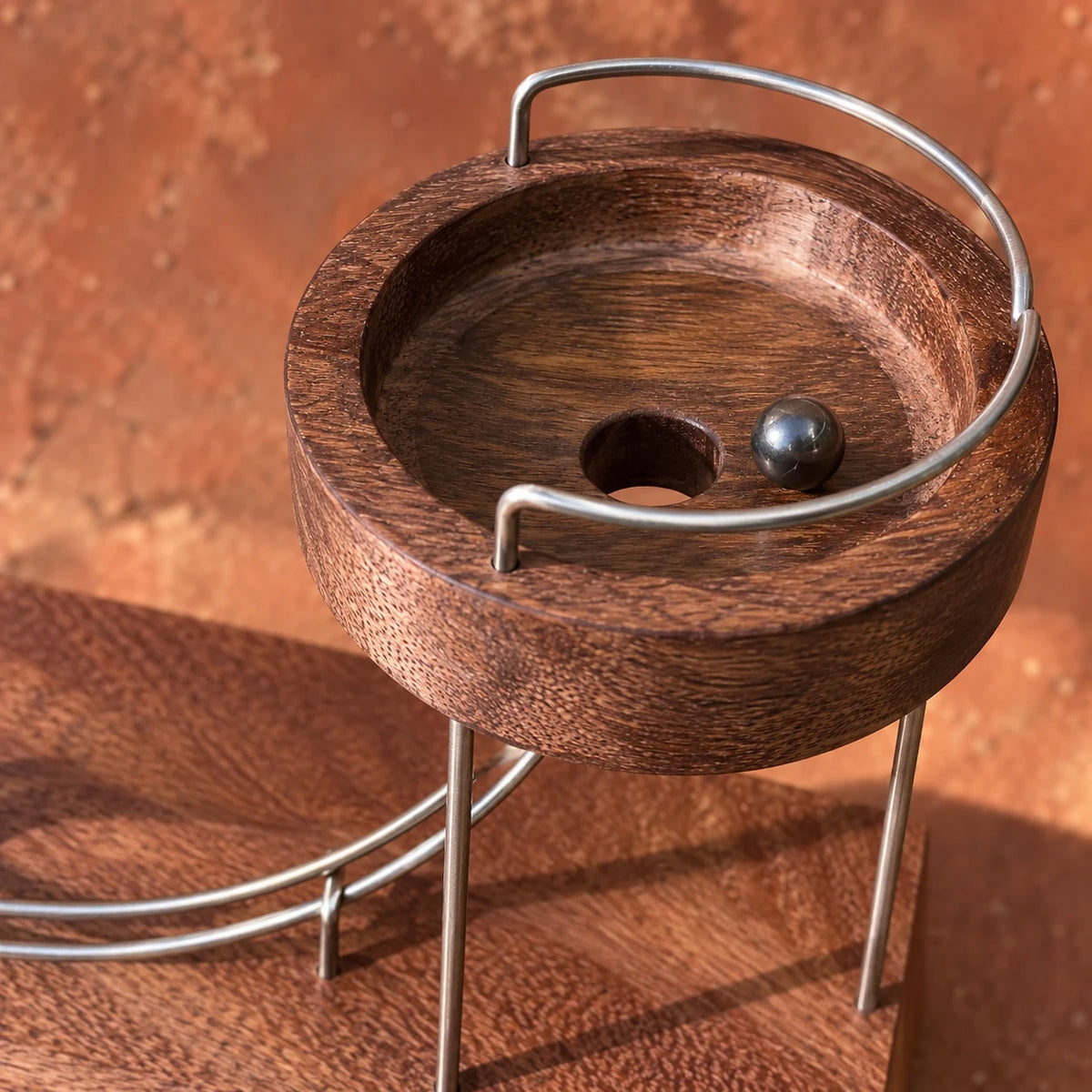 Close-up of the wooden bowl and metal ball