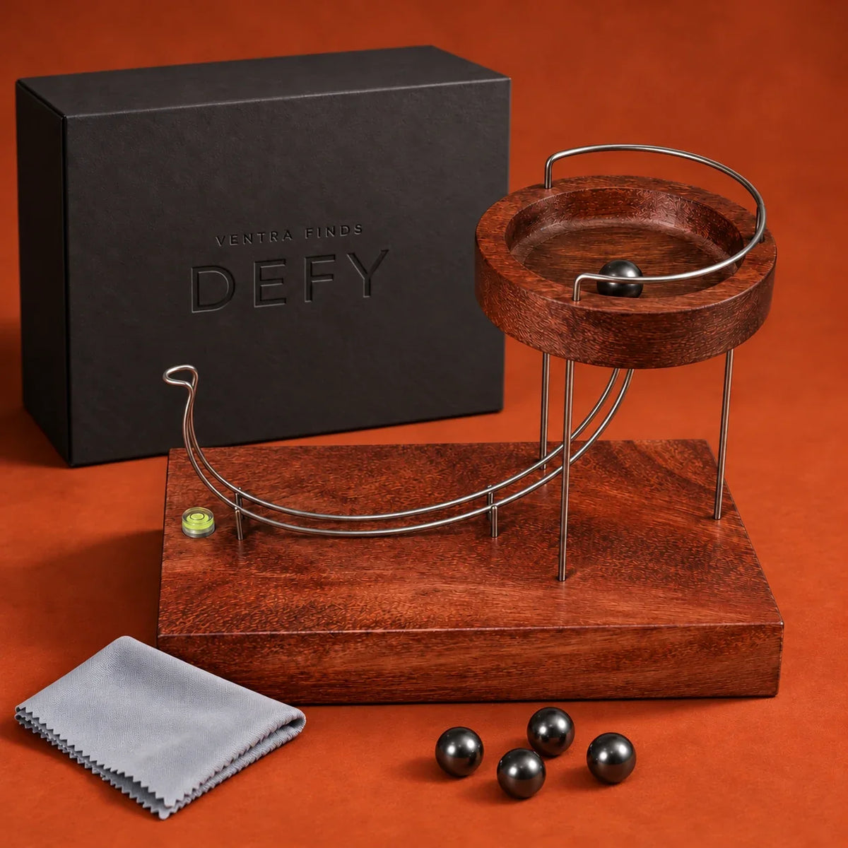 DEFY sculpture with branded presentation box, care cloth and five complimentary metal balls