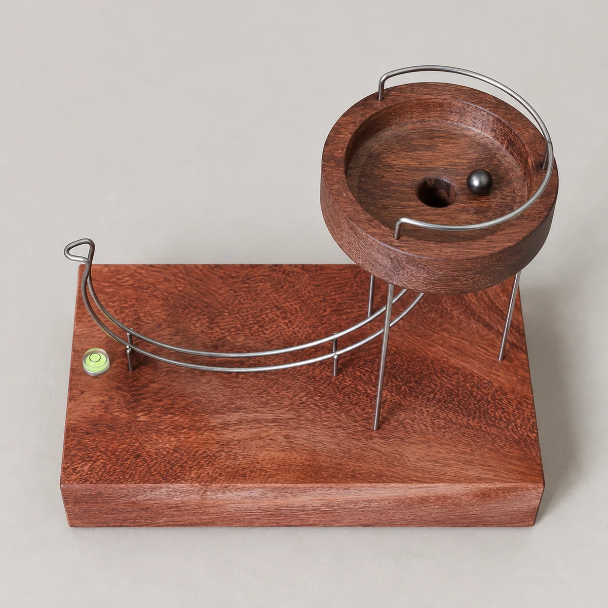 Defy kinetic sculpture from above, showing the wooden bowl and sweeping metal track