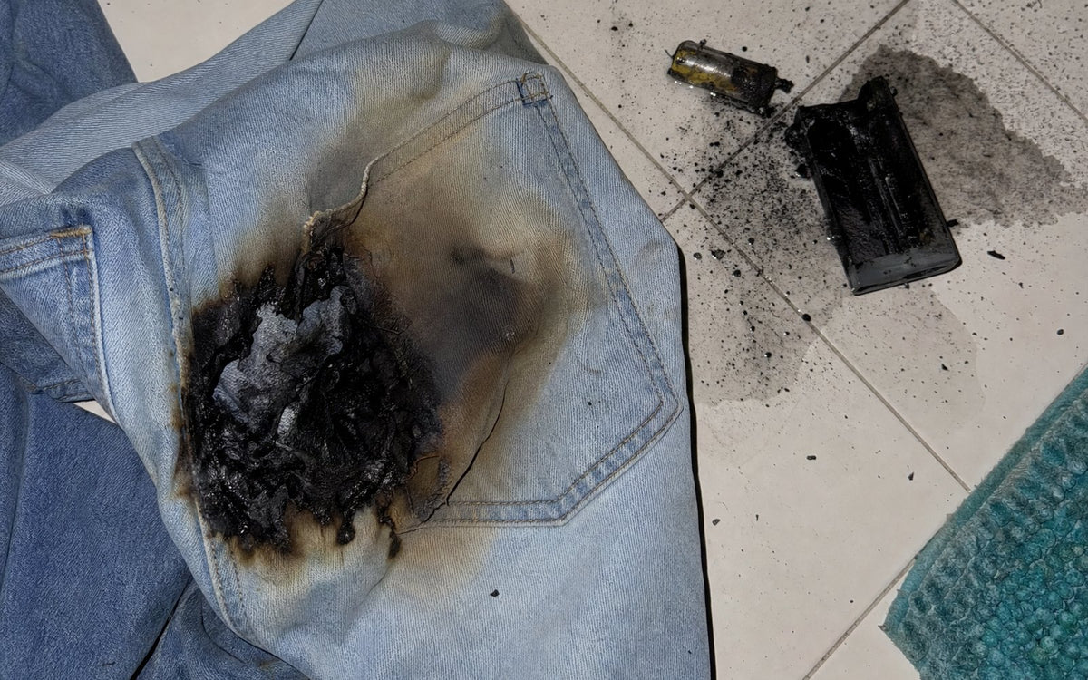 Jeans with a burned pocket next to a melted disposable vape