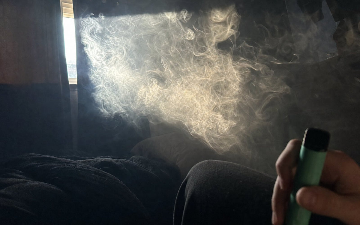 A cloud of vape aerosol hanging in a beam of sunlight