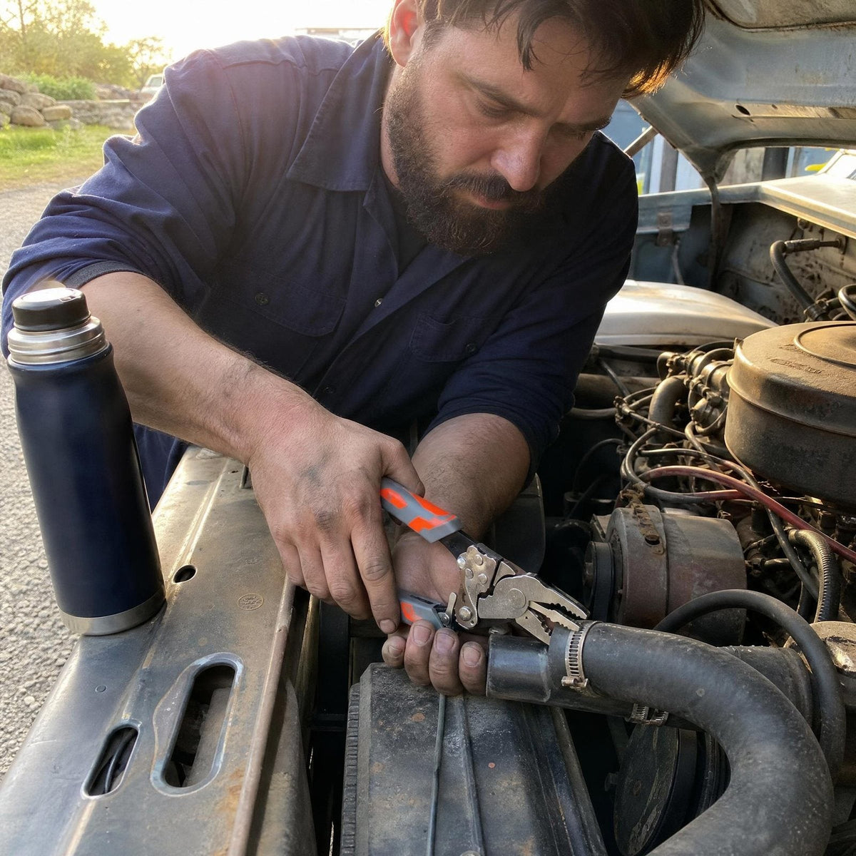 Mechanic clamping a radiator hose