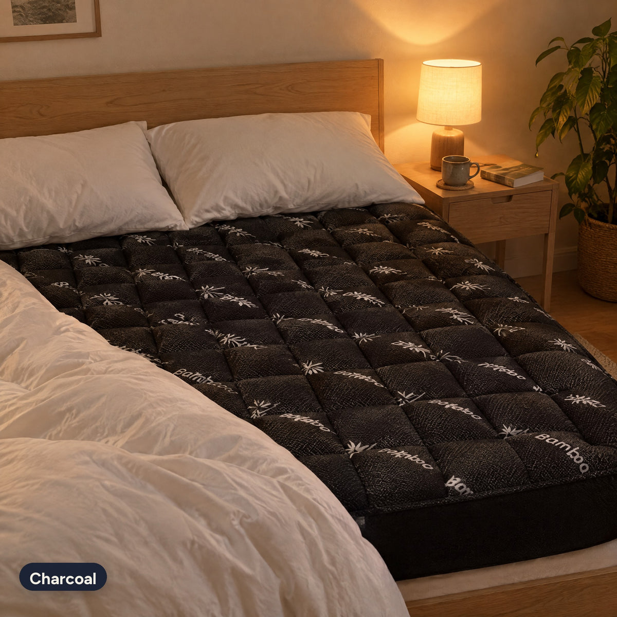 Charcoal Hushloft pillow-top on a bed in lamp light