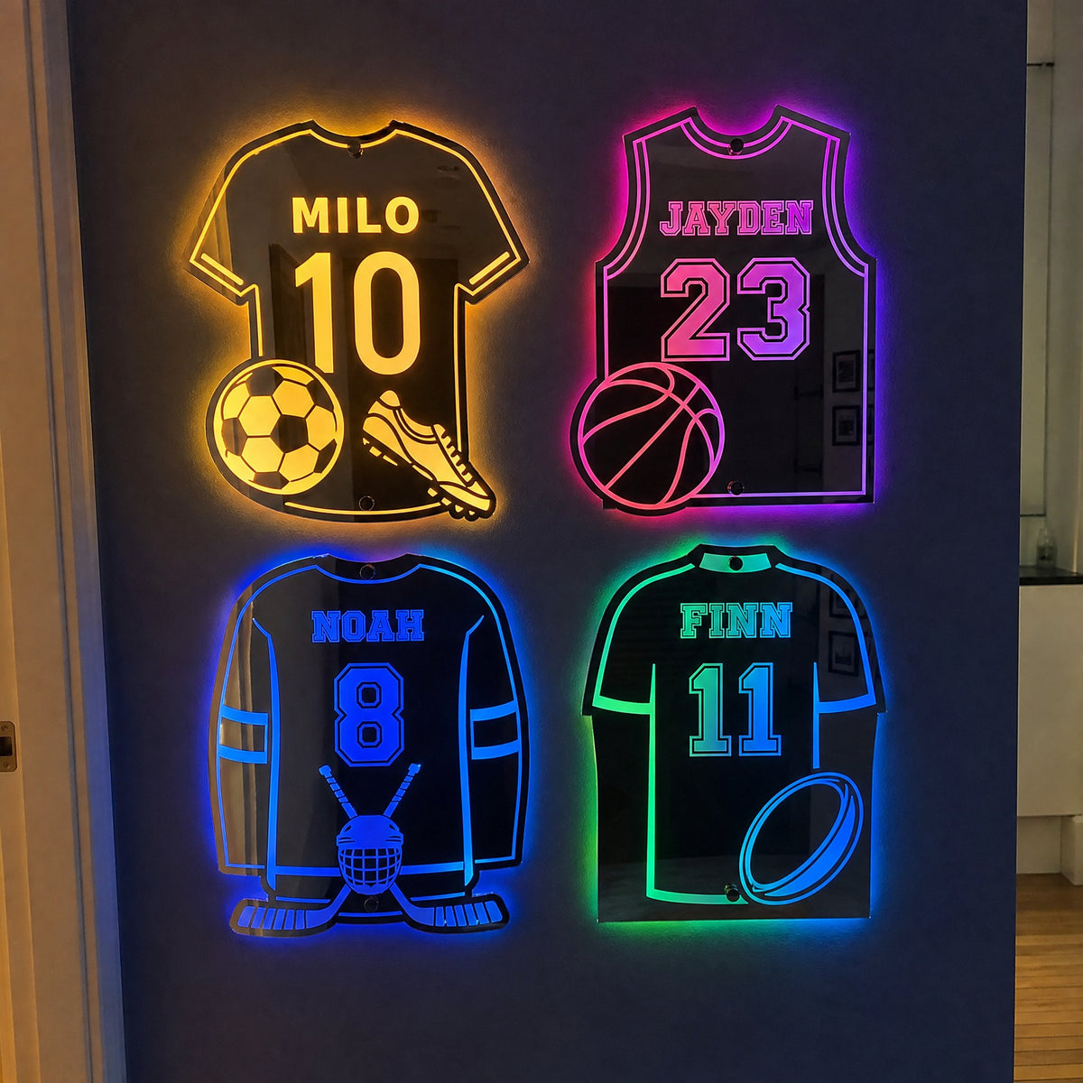 Soccer, basketball, hockey and rugby jersey mirrors glowing on one wall
