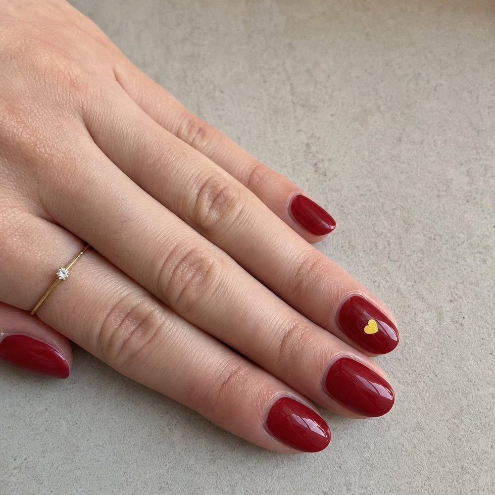 NightCheck sticker worn over red nail polish