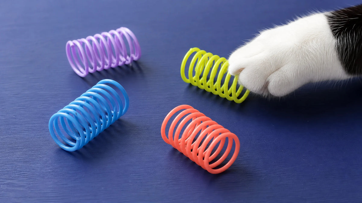 Four colorful plastic cat spring toys for the free PounceClub play pack