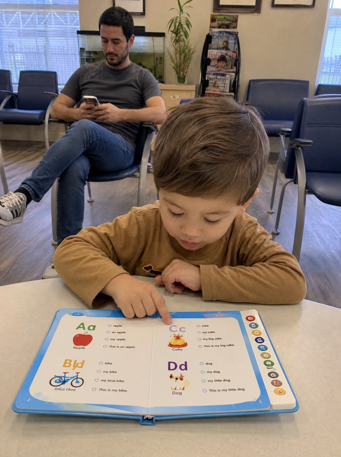 A boy reading in a clinic waiting room