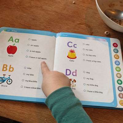 Sample customer photo: a child taps a line in the book