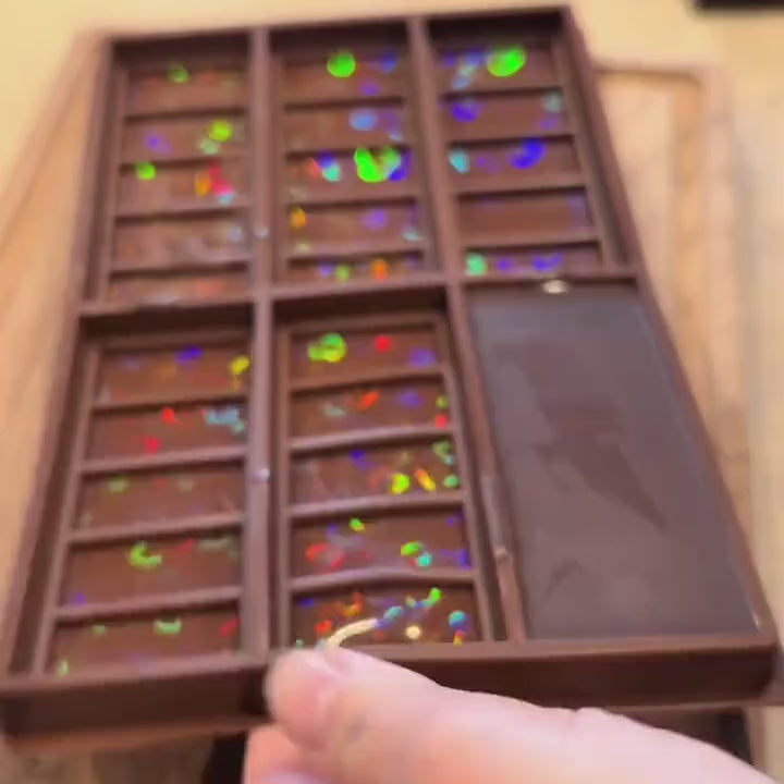 Real demo: a HoloPop chocolate bar popped out of the mold, its hearts flashing rainbow colors as it tilts in the light