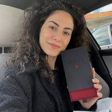 Sample reviewer holding the RUBRA box in her car
