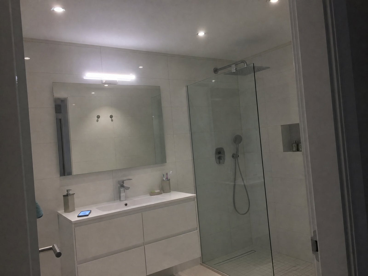The same bathroom at 10 PM under bright white lights