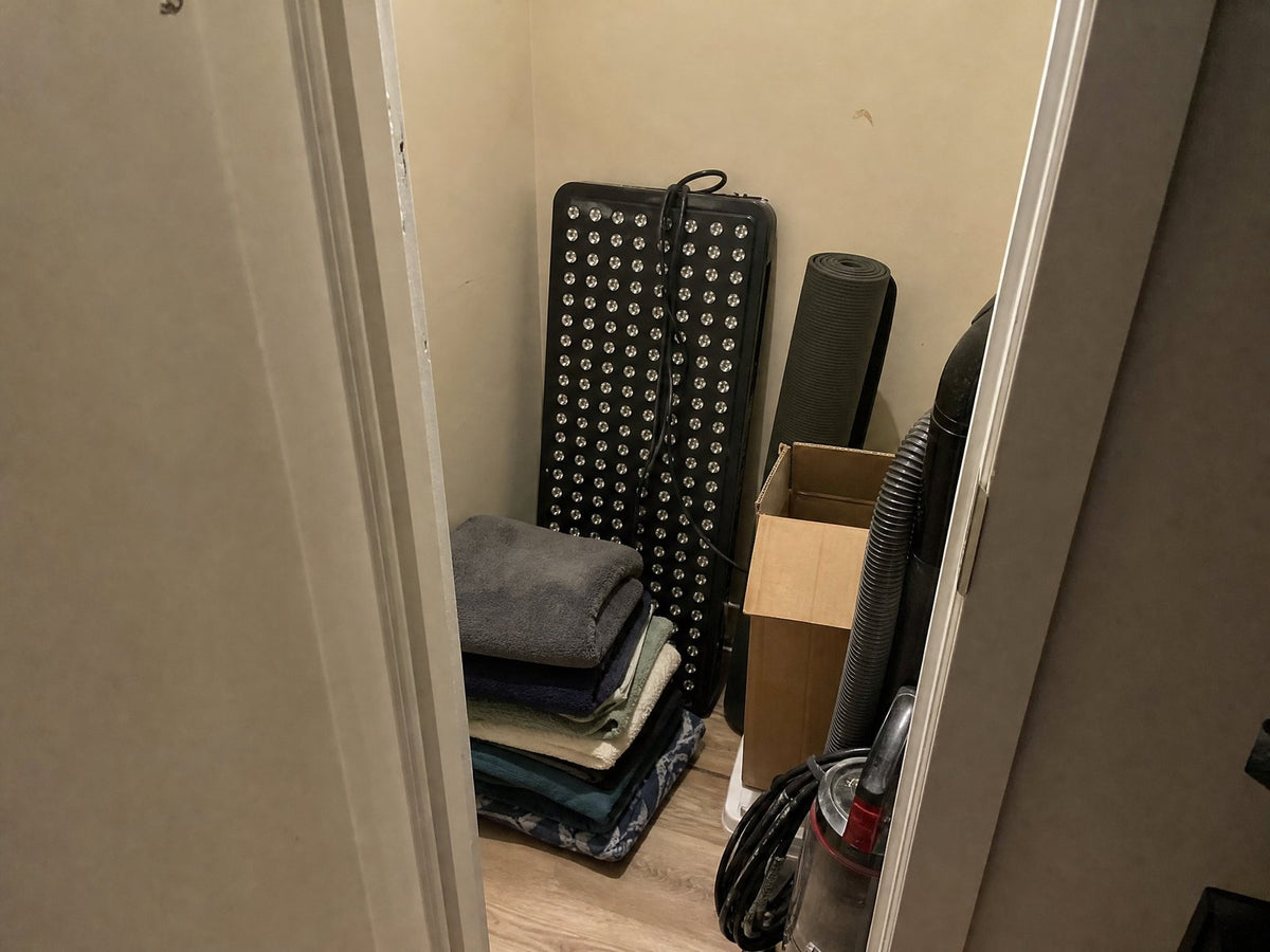 A red light panel stored in a closet
