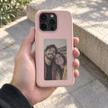 Reframe in Pink held in a hand with a personal photo design