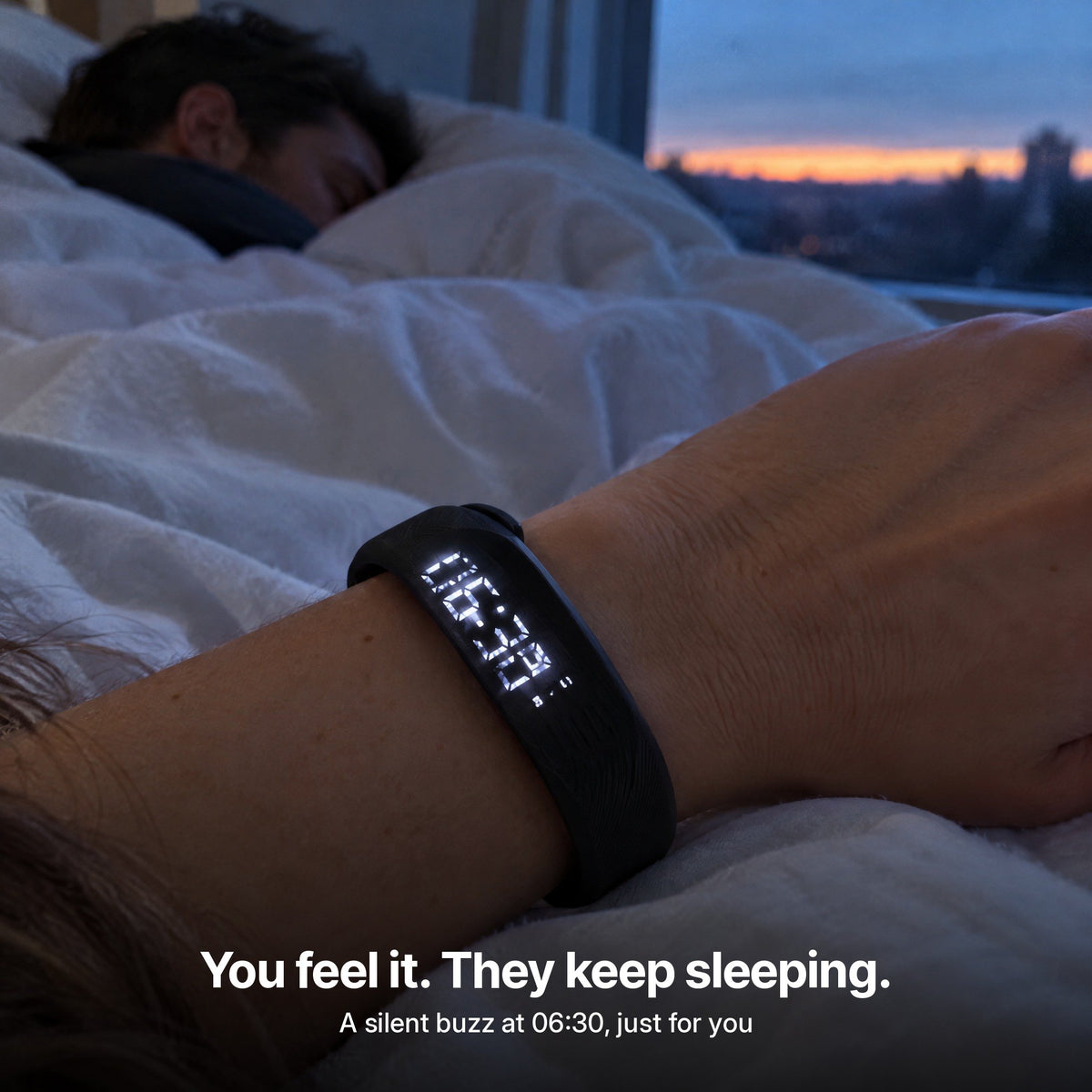 Rouse band glowing on a wrist at dawn while a partner keeps sleeping
