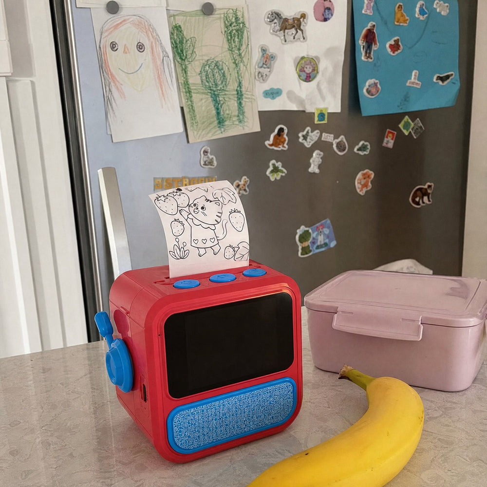 A fridge covered in colored stickers with the Saydoodle printer on the counter
