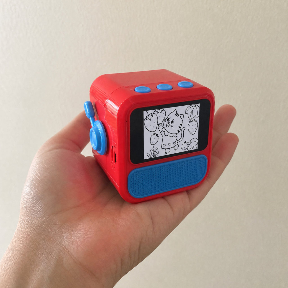 Saydoodle held in one palm