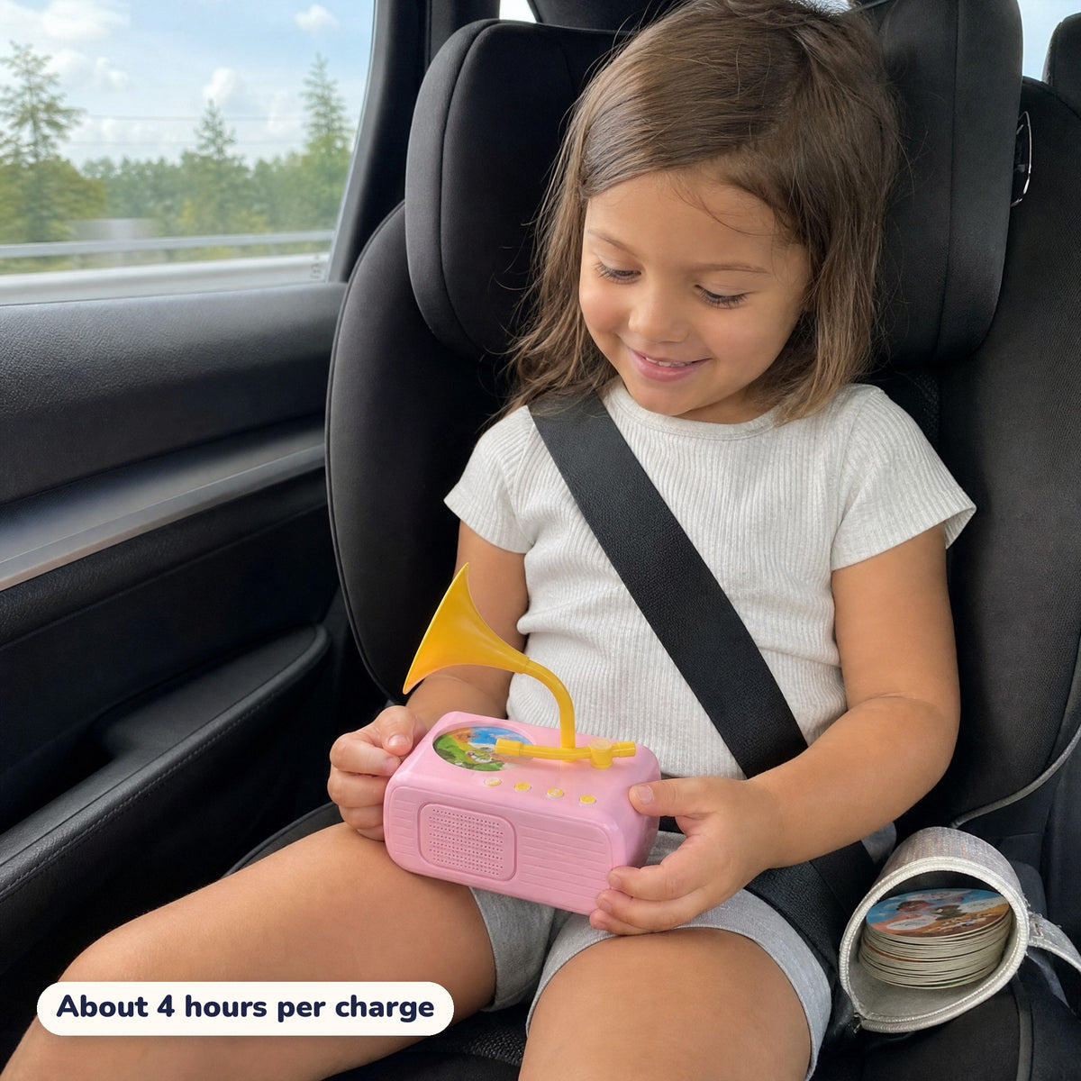A girl listening to her Storyhorn in her car seat