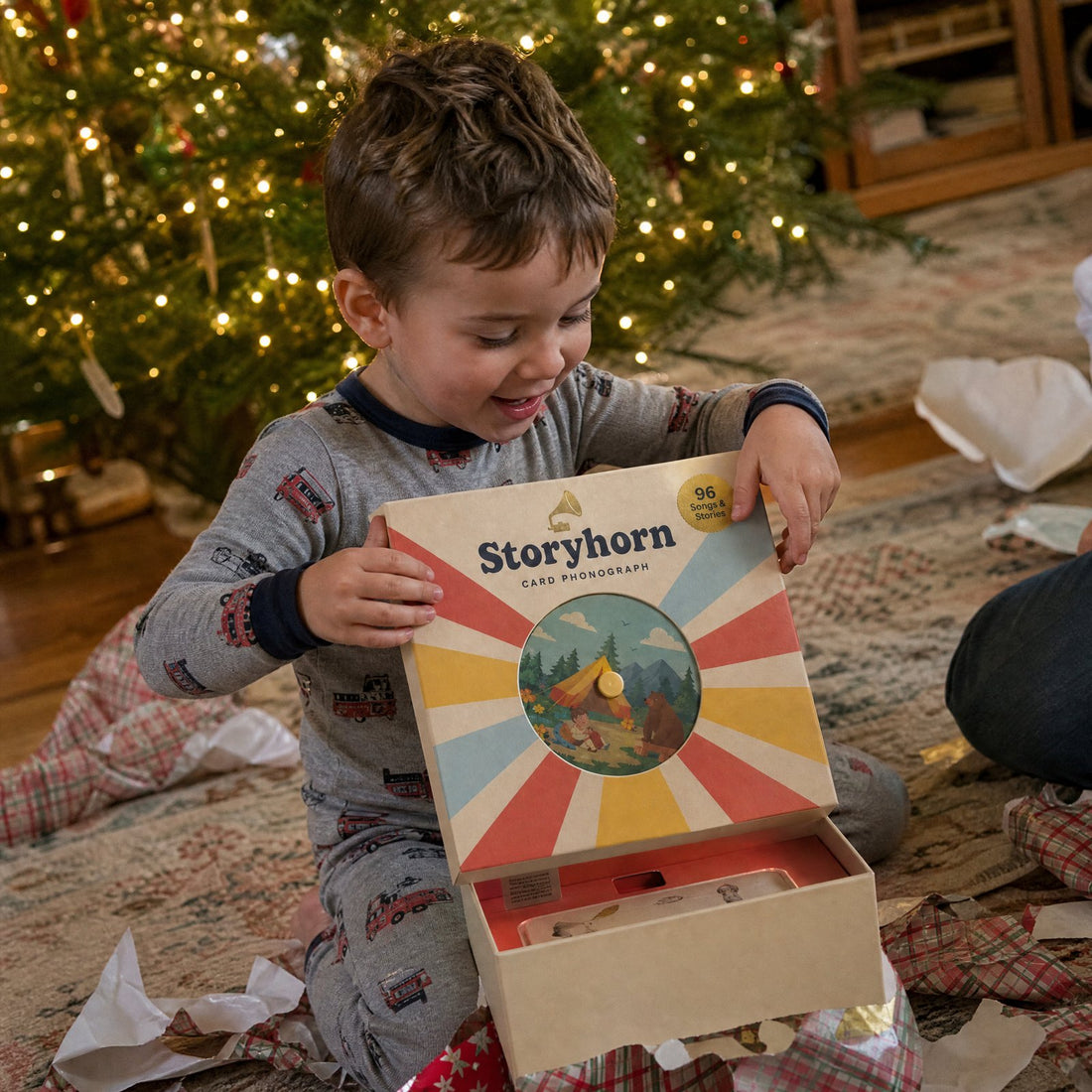 Boy unwrapping a Storyhorn on Christmas morning