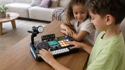 Children playing the black BeatLab DJ set at a living-room table.