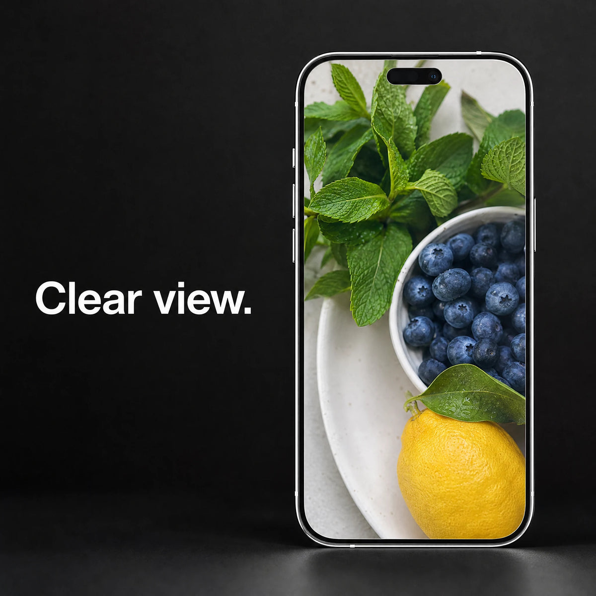 A phone showing green leaves, blueberries and a lemon through clear glass, with the words Clear view.