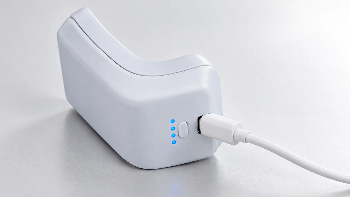 PlayPack recharging through its USB-C input beside a standard DualSense controller